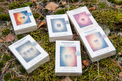 Six Swiderski mini puzzle boxes photographed on forest moss. Collection photograph; each mini puzzle is sold individually.